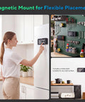 Super Sleek Hidden Camera Clock With 4K Wireless WiFi Surveillance mounted on a refrigerator with a woman adjusting the time.