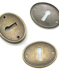 Top Tier 10 Pack Zinc Alloy Oval Keyhole Escutcheons Heavy Duty Antique Bronze Lock Covers, 3 oval plates with keyholes.