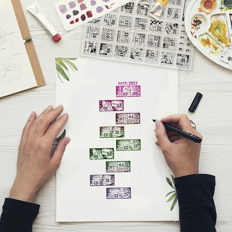 Hands using Vintage Date Clear Stamps Top Shelf Seal Set to create calendar layouts on paper for journal and scrapbooking.