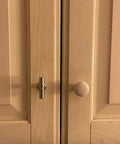 Close-up of kitchen cabinet with simple steel knob next to wooden round knob, showing potential upgrade with 10 Pack Modern Cabinet Pull Handles In Gold Matte Stainless Steel Hardware For Kitchen And Dresser Drawers, Two Tone Mounting Brackets, Durable And Sleek Gold Accent For Easy Cabinet Upgrades.