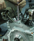 Close-up of HDLNKAK telescoping bore gauge set in stainless steel being used to measure an engine cylinder bore.