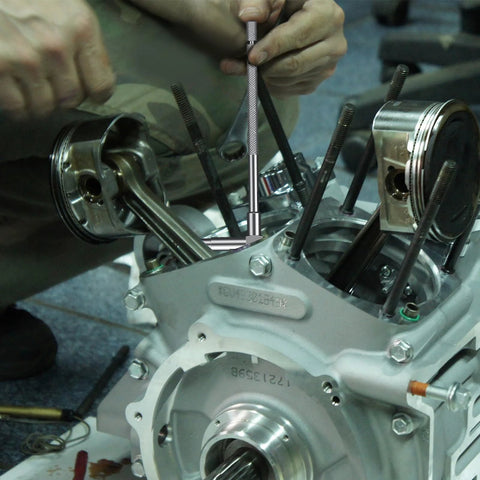 Close-up of HDLNKAK telescoping bore gauge set in stainless steel being used to measure an engine cylinder bore.