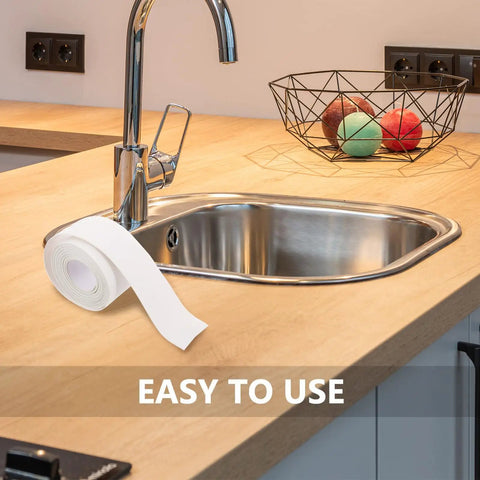 Super Easy White PVC Caulking Tape For Bathtub And Window Gaps Peels Sticks And Seals To Stop Water Leaks Without Messy Tools on kitchen counter next to sink.