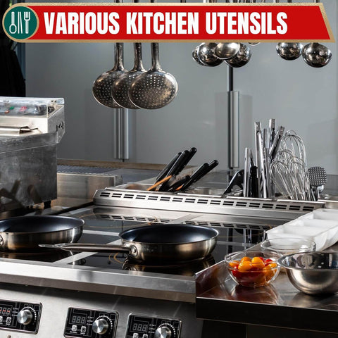 Modern kitchen with various utensils and cooking pans on a stove.