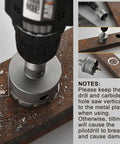 2-inch tungsten carbide hole saw with titanium-plated pilot drill bit, mounted on a drill cutting a rusted metal plate