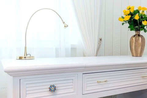 Handmade Flower Ceramic Knob Set of 10 with Colorful Multi Design Cabinet Knobs for Doors Drawers Cabinets Ideal for Home Kitchen Office Includes Wrench Screws Caps and Bolts on white cabinet drawer with lamp and vase.