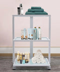 Three Tier Beauty Cart On Wheels With Heavy Duty 330 Lb Capacity All Purpose Rolling Trolley Organizer with towels and bottles visible