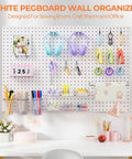 Badass Heavy Duty Metal Pegboard Wall Storage Kit With 90 Pieces Of Hooks Bins Cups Paper Towel Holder And Steel Tray For Garage Workshop Organization in a bright sewing room.