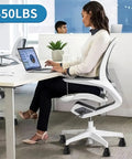 Silent Stationary Chair Feet For Office Seats Durable Rubber Glides Smooth Floor under a desk, supporting a woman working on a laptop.