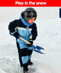 Child playing with Three Piece Metal Beach Shovel Set For Kids, 16 Inch Sand Shovels With Wooden Handles in snowy winter scene.