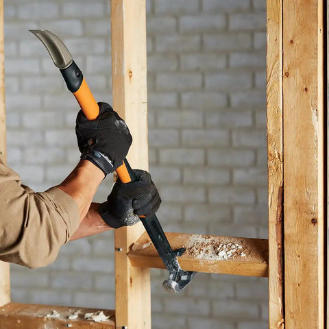Person using IsoCore Wrecking Bar And Crowbar With Board Bender, Shock Absorbing Hammer, 30 Inch Pry Bar for prying wood in construction.