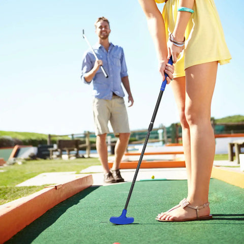 Person using Two Way Mini Golf Putter Set Four Pack With Adjustable Length Includes Four Balls Right Or Left Handed Golf Putters outdoors.