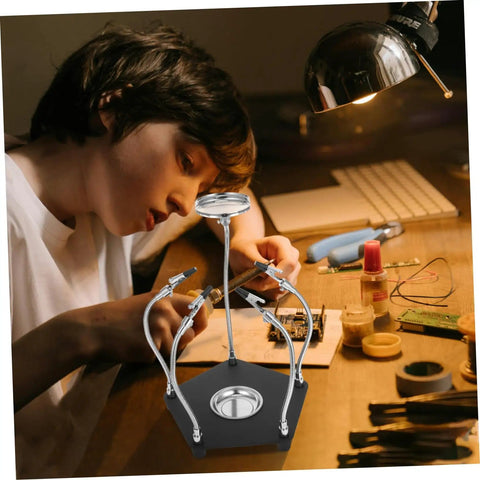 Child using Magnetic Third Hand Soldering Aid With Built In Magnifier For Crafts And PCB Work at a workbench