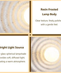 MECOLA Round Resin Accent Wall Sconce Small Glass Globe Shade Wall Lamp showcasing frosted resin body and bright light source.