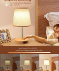 Person using Lit LED Table Lamp With Touch Dimmer USB C Charging Ports Height Adjustable Bedside Nightstand Lamp on nightstand.