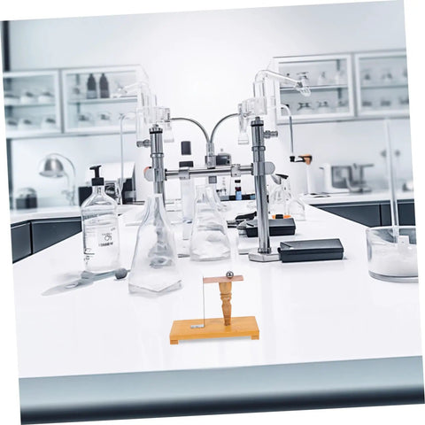 Easy To Use Pendulum Inertia Demonstrator For Physics Labs on a classroom table with lab equipment.