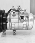 Automotive AC compressor showing metal fittings and pulley, related to Three Piece R134a Adapter Fittings Set With Hose.
