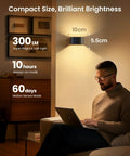 Man using laptop under Motion Sensor Wall Light With Remote Control No Fuss Three Color Modes Wireless LED Indoor Up And Down Wall Sconce 5000mAh Rechargeable Battery Powered Brightness Adjustable Two Pack illuminated in a room.