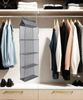 Rock Solid Four Layer Closet Hanging Shelf With Sturdy Hook Nonwoven Mesh Bag Organizer Space Saver Massive Storage For Clothes Snacks And Gear Easy Hang Breathable Fabric Rack in closet with shirts and shoes.