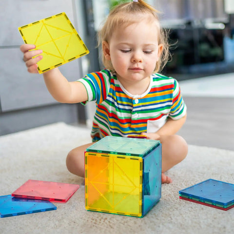 Child playing with 12 Piece Large Magnetic Tiles Set For Kids Jumbo 5.9 Inch Magnetic Base Plates STEM Building Blocks.