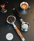 Kickstart Your Brew Routine With Top Shelf 58mm Bottomless Portafilter featuring wooden handle, beans in basket, and latte art.