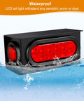All In One Steel Trailer Light Box Kit with 6 inch oval red 10 LED tail lights submerged in water showcasing waterproof feature