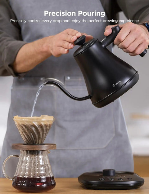 Smart Electric Kettle With WiFi And Alexa Control For Home Baristas Gooseneck Pour Over Kettle With Variable Temperature 1200W Quick Heat 0.8L Capacity One Hundred Percent Stainless Steel Matte Black shown pouring water over coffee dripper.
