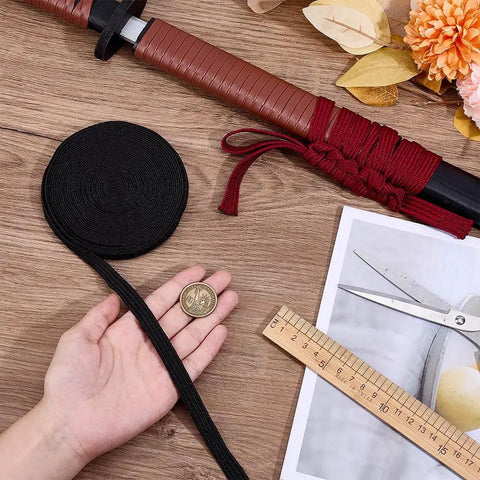 7M Black Ito Sageo Wrapping Cord 0.5 Inch Wide Silk Cotton Blend Rope for Katana Handle Tsukamaki, next to a hand and coin