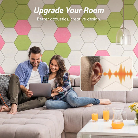 Couple with laptop on couch, wall with 12 Pack High Density Hexagon Acoustic Panels For Serious Noise Reduction With 0.9 NRC Peel And Stick Wall Decor