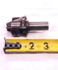 Adjustable No 00 hollow mill with five eighth inch shank made in USA, laid next to tape measure for scale