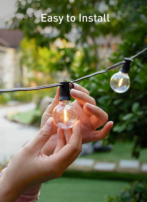 Hands installing LED Outdoor String Lights 109 Ft With 52 Edison Shatterproof Bulbs Plus 2 Spares, Dimmable, Energy Saving