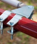 Close-up of heavy duty solar dual automatic gate opener kit featuring metal bracket and bolts on red swing gate