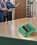 8 Channel Optocoupler Isolator Module For PLC DC Output Board on table with engineers in background