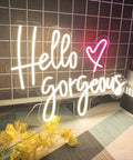 Totally Lit Warm White LED Neon Sign For Weddings And Parties Bedroom Bar And Home Decor 19.7 By 14.1 Inches Neon Light Wall Art That Brightens Any Space For Any Room Or Space showing 'Hello Gorgeous' with heart on grid wall backdrop