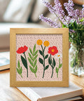 Wildflower Punch Needle Kit Two Pack For Beginners, Embroidery Set with floral pre-printed fabric in wooden frame on table