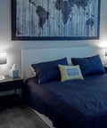 Bedroom scene with 2 pack bedside table lamps with USB port and AC outlet on nightstands, white shades on nickel bases, illuminated.