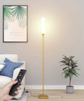 Gold Floor Lamp With Remote And Foot Switch, 360 Degree LED Light, shown in a modern living room setting with remote control in hand.