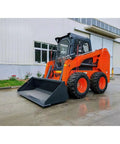 Compact Mini Track Skid Steer Loader Workhorse For Construction, Landscaping And Material Handling Tasks in front of building