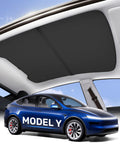 Installed black sunshade for Tesla Model Y panoramic glass roof, interior view