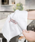 Person wiping a spoon with Pack Of 50 White 12 By 12 Inch Cotton Terry Cleaning Cloths For Auto Detailing, Painters, And General Cleaning
