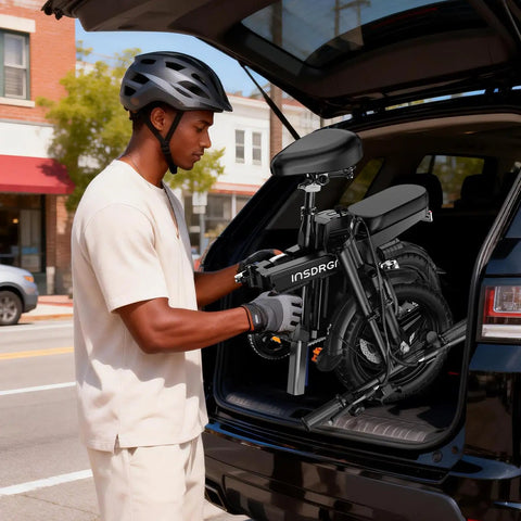Man loading Foldable 14 Inch Electric Bike For Adults With 1500W Peak Motor Top Speed 20 MPH Removable 48V 16Ah Battery into car trunk