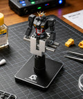 Mini Tabletop Vise That Converts to Handheld, 360 Degree Rotatable Precision Bench Clamp holding model on desk