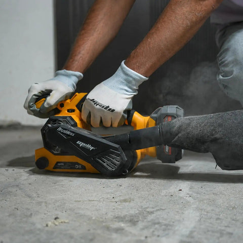 Badass Cordless Brushless Belt Sander With Six Variable Speed Settings and Raw Grip in use, sanding rough wood close-up.
