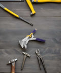 Hand Seamer Straight Jaw Sheet Metal Bender Tool with Textured Locking Pliers on wood surface, surrounded by other tools.