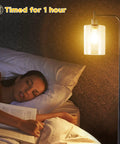 Lit Industrial Floor Lamp In Black And Gold With Clear Glass Shade next to woman sleeping