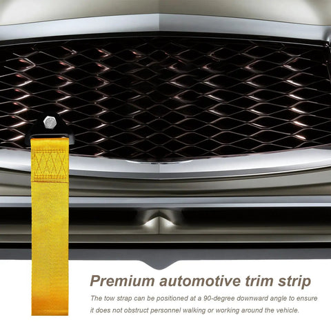 Heavy Duty Racing Tow Strap And Nylon Towing Rope For Jdm Sports Cars, Universal Front Or Rear Bumper Recovery Line, 2000 Pound Towing Pull With Badass Construction And No Nonsense Grip In Bold Yellow mounted on vehicle grille.