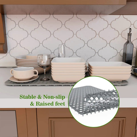 Silicone Kitchen Sink Mat With Non Slip Design, Stable Farmhouse Sink Protector shown cushioning dishes on countertop.