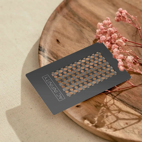 Grinder Card Manual Pepper And Spice Grater Tool In Black Aluminum on wooden tray with flowers