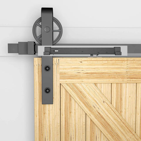 Top view of Stainless Steel Barn Door Soft Close Mechanism Kit With Adjustable Tension Spring Damper And Included Actuator Spacers, Hole Free No Drilling For Flat Track Doors Weighing 77 To 132 Pounds, Easy Install, 2 Pack installed on wooden door.