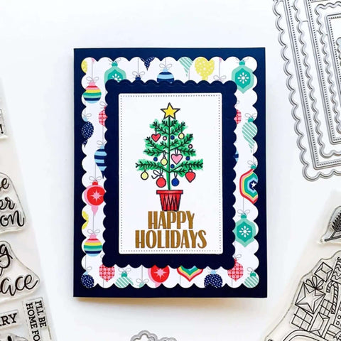 Handmade holiday card using rectangle frame metal die cuts set with scalloped edges and stitched nesting tags for card making.